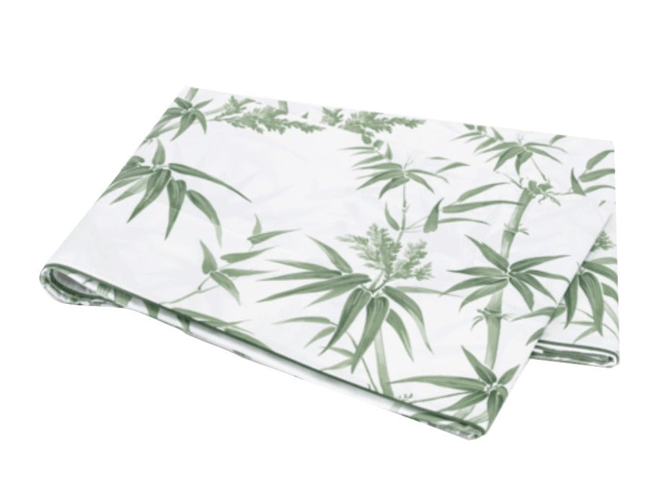 A folded white sheet from the Matouk Dominique Bedding Collection, Palm, made of luxurious Egyptian cotton with a green palm leaf pattern, displayed on a plain white background.