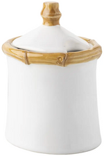The Juliska Bamboo Lidded Sugar Bowl is a white ceramic bowl with tan bamboo accents on the rim and handle—ideal for elevating your morning coffee routine.