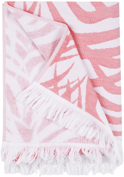 A Matouk Zebra Palm Beach Towel in Flamingo, with a fringed edge, folded partially to showcase its pattern and texture, featuring tropical leaves.