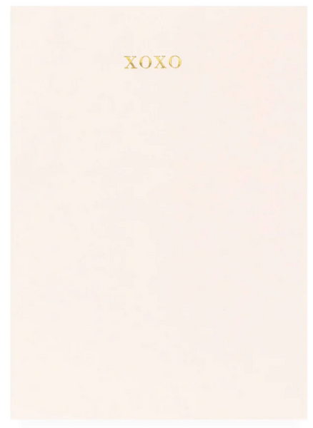 Pale peach background with the letters "xoxo" in a golden font centered towards the top, showcasing Sugar Paper's Mini Pad Pink XOXO designs.