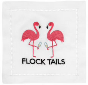 August Morgan’s Flock Tails Cocktail Napkins feature two pink flamingos on one leg, facing each other with cocktail glasses, and "FLOCK TAILS" below, all on elegant cotton napkins with classic hemstitching.