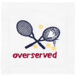 The Overserved Blue Cocktail Napkins by August Morgan feature two crossed tennis rackets (one broken) with tennis balls and “overserved” stitched in red—a witty, playful accent for your table. Classic linen with hemstitching adds charm.