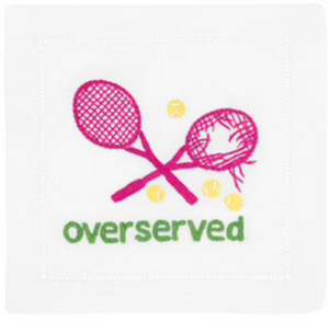 The Overserved Pink Cocktail Napkins by August Morgan feature two pink tennis rackets and yellow tennis balls around "overserved" embroidered in green on elegant linen with classic hemstitching.