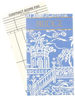 The Caspari Pagoda Toile Blue Bridge Score Pad features a stylish blue and white cover with gold lettering—a perfect hostess gift for bridge lovers who appreciate elegant scoring accessories.