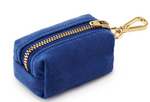 The Foggy Dog Dog Waste Bag Dispenser is a small blue fabric pouch with a gold zipper and leash clip. Its compact design makes it ideal for carrying essentials or eco-friendly poop bags while on the go.