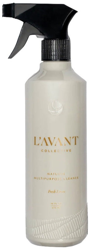 A white recycled plastic bottle labeled "L'Avant Collective Fresh Linen Multipurpose Cleaner" features a modern black trigger sprayer.