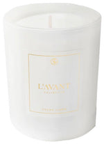 The Fresh Linen Candle by L’Avant Collective is a white soy and coconut blend candle in a glass container, labeled with gold text.