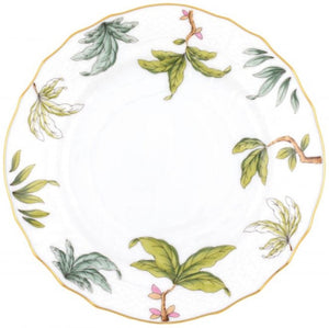 A white porcelain plate from Herend’s Foret Garland Collection features a scalloped gold rim and hand-painted green leaves with pink flowers spaced around the border.