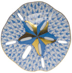 The Sand Dollar by Herend features a blue scallop pattern, gold and blue star-shaped center, and six oval cutouts—an exquisite hand-painted porcelain plate inspired by artistic tradition.