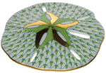 The Herend Sand Dollar porcelain plate features a hand-painted green and gold sand dollar motif with a patterned background and gold-rimmed edge—ideal for artistic display or collectors of fine porcelain.