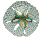 The Herend Sand Dollar porcelain plate features green and white scalloped edges, a gold and green star center, and oval cut-outs—an artistic decorative piece.