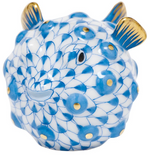 The Herend Puffer Fish figurine features blue scales, gold-accented fins and spikes, a smiling face, and exquisite hand-painted details in classic Herend porcelain.