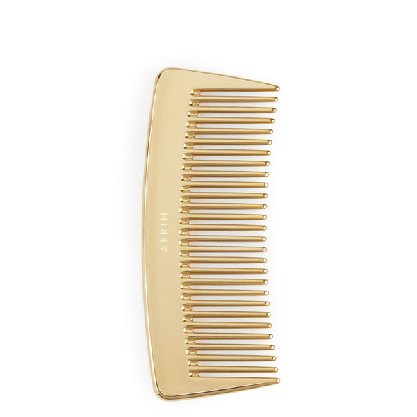 A luxurious interpretation of the AERIN Travel Gold Comb, set against a pristine white background.