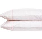 The Poseti Lotus Pillowcase Pair by John Robshaw features light pink patterns and a pink zigzag stitch—an essential layering addition to any versatile color palette.