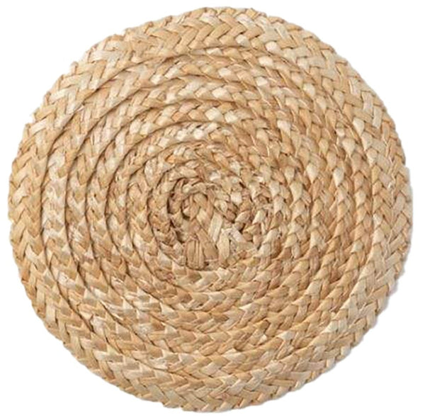 A handwoven Mila Round Natural Straw Coasters on a white background by Blue Pheasant.