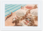 People relaxing by a swimming pool at the Gray Malin Coral Casino Beach & Cabana Club on sun loungers under white umbrellas.
