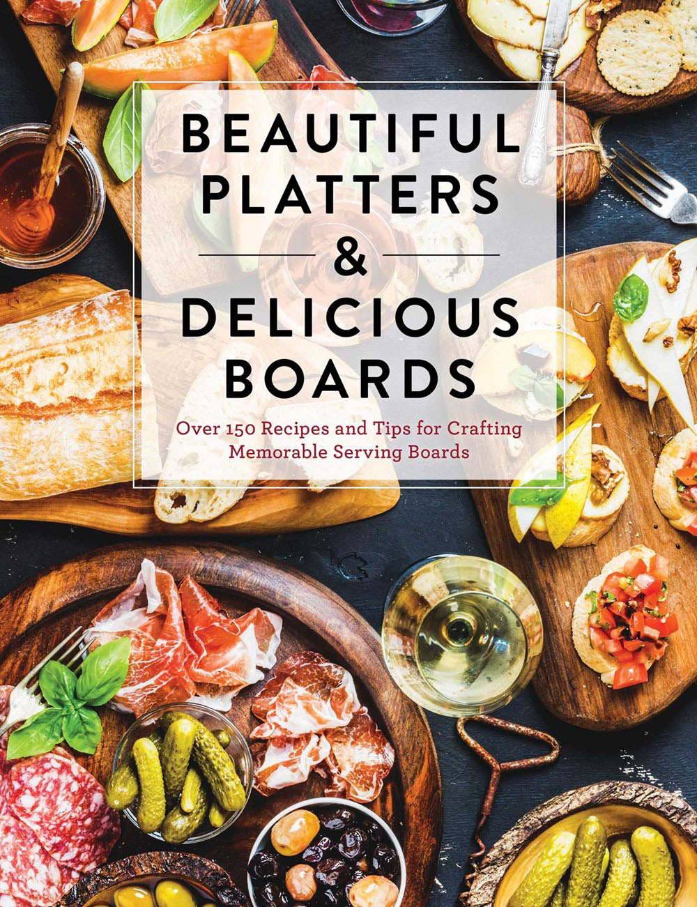 Recipe book cover titled "Beautiful Platters & Delicious Boards" by Common Ground, showcasing stunning photos of assorted foods like cheese, bread, and wine artfully arranged on serving boards.
