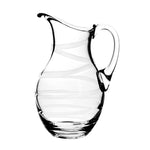The Bella Bianca Pitcher by William Yeoward Crystal is a clear handmade glass pitcher featuring a curved handle and elegant white spiral swirl patterns, shown against a plain white background.