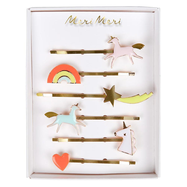 A collection of Meri Meri Unicorn Enamel Hair Slides featuring unicorn, rainbow, star, and heart designs with neon detail in a display box.