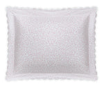 The Matouk Celine Bedding Collection in Pink features a rectangular white pillow with scalloped edges and small red dots, made from OEKO-TEX certified Egyptian cotton percale for premium softness and quality.