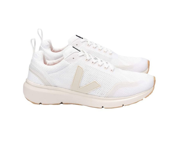 Pair of white Veja Women's Condor 2 Alveomesh sneakers with a tan sole and a prominent 'v' logo on the side, crafted from bio-based/recycled materials.
