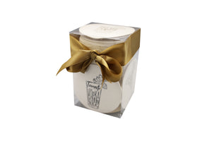 A package of white round Cocktails coasters tied with a gold ribbon by Haute Papier.