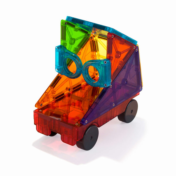 Colorful magnetic toy truck made of non-toxic, translucent Magna-Tiles Clear Colors panels, assembled in a geometric design with black wheels, on a white background.