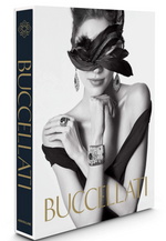 The book "Buccellati: A Century of Timeless Beauty" by Assouline features a cover with a woman in a black dress, feathered eye mask, and ornate Buccellati jewelry, showcasing traditional craftsmanship.
