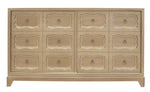 The Dorothy Door Chest by Kindel is a cerused white wooden dresser with a light finish, featuring three rows of six drawers adorned with decorative carved borders and brass ring pulls, offering a touch of Dorothy Draper elegance.