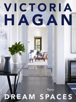 Cover of "Victoria Hagan: Dream Spaces" by Rizzoli, highlighting her design philosophy with a chic hallway, a console table, and a glimpse into a luminous, comfortably furnished living room that exemplifies soft modern interiors.