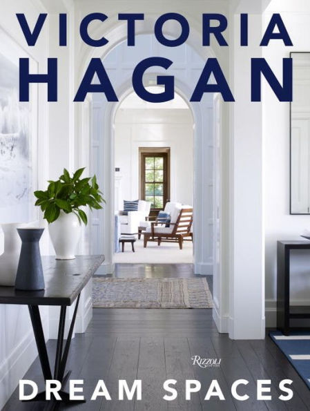 Cover of "Victoria Hagan: Dream Spaces" by Rizzoli, highlighting her design philosophy with a chic hallway, a console table, and a glimpse into a luminous, comfortably furnished living room that exemplifies soft modern interiors.