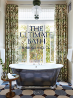 A black freestanding tub sits before large windows with floral curtains; “The Ultimate Bath by Barbara Sallick” from Penguin Random House is shown, offering inspiration for luxurious bathrooms and elegant bath design.