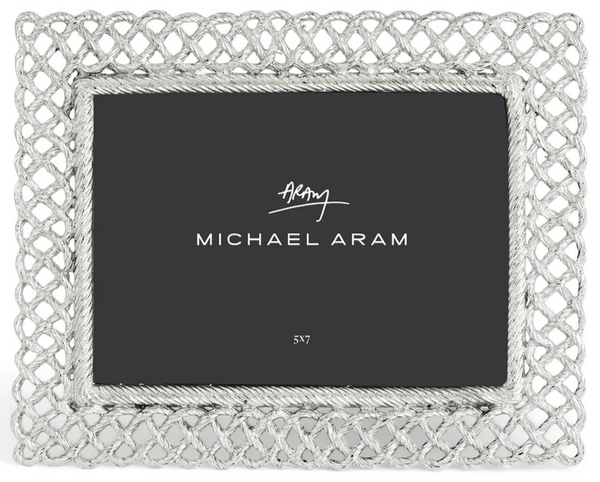 A Michael Aram-branded Love Knot Frame Silver, 5” X 7” from the Love Knot Collection, featuring an intricate, net-like metallic border design that symbolizes love.