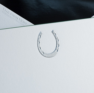 A silver horseshoe adorns white paper with a green square corner, while "Printery" branding appears in the background—part of the Horseshoe Card Set.