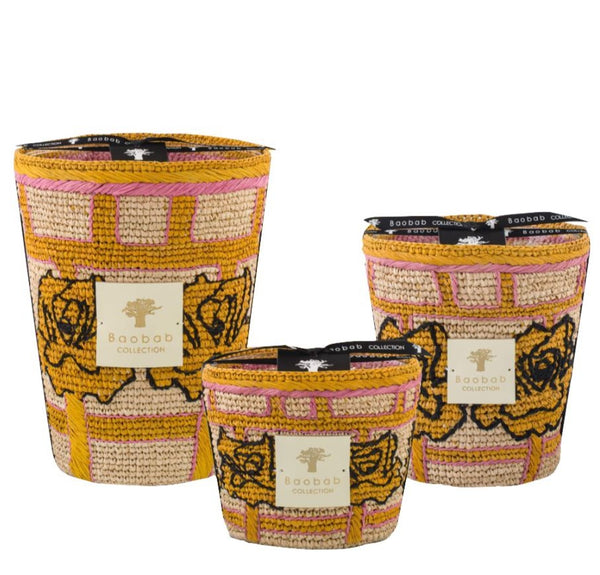 Three Baobab Frida Draozy Diego Candle Collection scented candles in various sizes, featuring a floral design on a woven textured background in orange and pink shades, including an orchid scented candle.