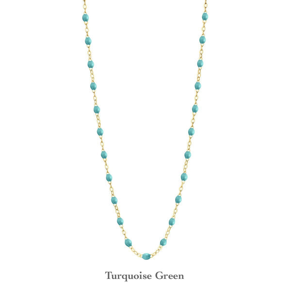 A turquoise green beaded Gigi Clozeau Classic Gigi Necklace with 18 carat Yellow Gold links on a white background.