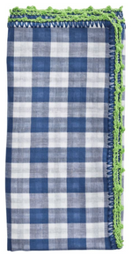 The Kim Seybert Gingham Check Napkin Set features neatly folded cotton napkins with a blue checkered pattern, each accented by a delicate green crochet edge.