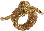 The Kim Seybert Glam Gold Knot Napkin Ring features a gold finish with sleek detailing, displayed against a white background.