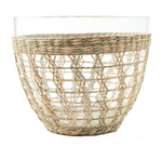 The Be Home Seagrass Cage Serving Bowl features a clear glass bowl partially wrapped with woven seagrass, creating a decorative pattern perfect for indoor or outdoor dining.