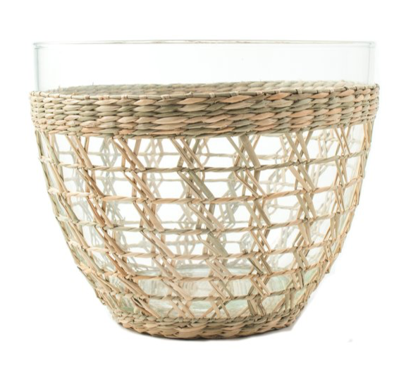 The Be Home Seagrass Cage Serving Bowl features a clear glass bowl partially wrapped with woven seagrass, creating a decorative pattern perfect for indoor or outdoor dining.