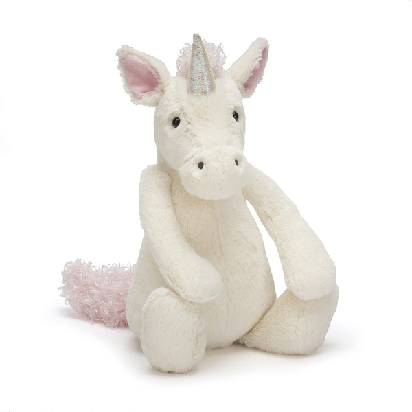 A white stuffed unicorn, part of the Jellycat designs collection, sitting on a white background.