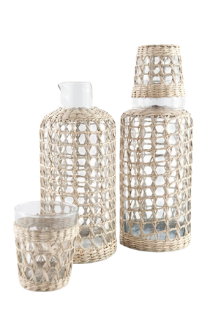 The Be Home Seagrass Cage Carafe features clear glass wrapped in beautiful seagrass. Handwash is recommended to maintain its natural charm.
