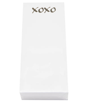 The XOXO Skinny Notepad by Black Ink comes in a rectangular white box featuring a gold foil icon and "XOXO" in silver at the top, all crafted from luxurious smooth cardstock.