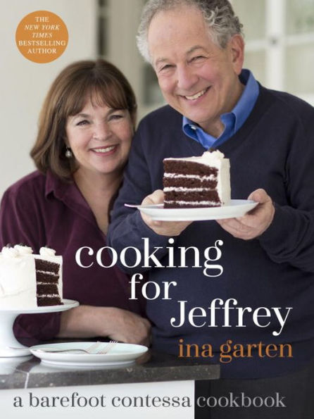 A man and woman smile while holding a plate with a slice of chocolate cake, embodying the warmth of "Cooking for Jeffrey" by Penguin Random House.