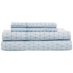 The John Robshaw Kama Bedding Collection features cool, crisp organic percale cotton bed sheets with a light blue circular pattern on white, neatly folded and including two flat sheets and two pillowcases.