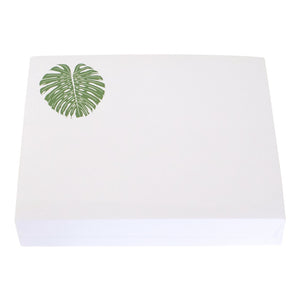 The Black Ink Monstera Leaf Large Notepad features a white rectangular Lucite holder and luxurious note paper with a green monstera leaf in the top left corner. Size: 8.5" x 7".