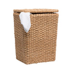 The Marennes Hamper by Pigeon & Poodle is a rectangular lidded basket made of seagrass, with a white cloth draped over one edge and displayed on a plain white background.