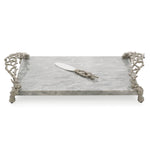 The Michael Aram Ocean Reef Cheese Board with Knife features a rectangular marble tray with decorative metallic handles and feet, plus a matching knife, inspired by ocean floor patterns.