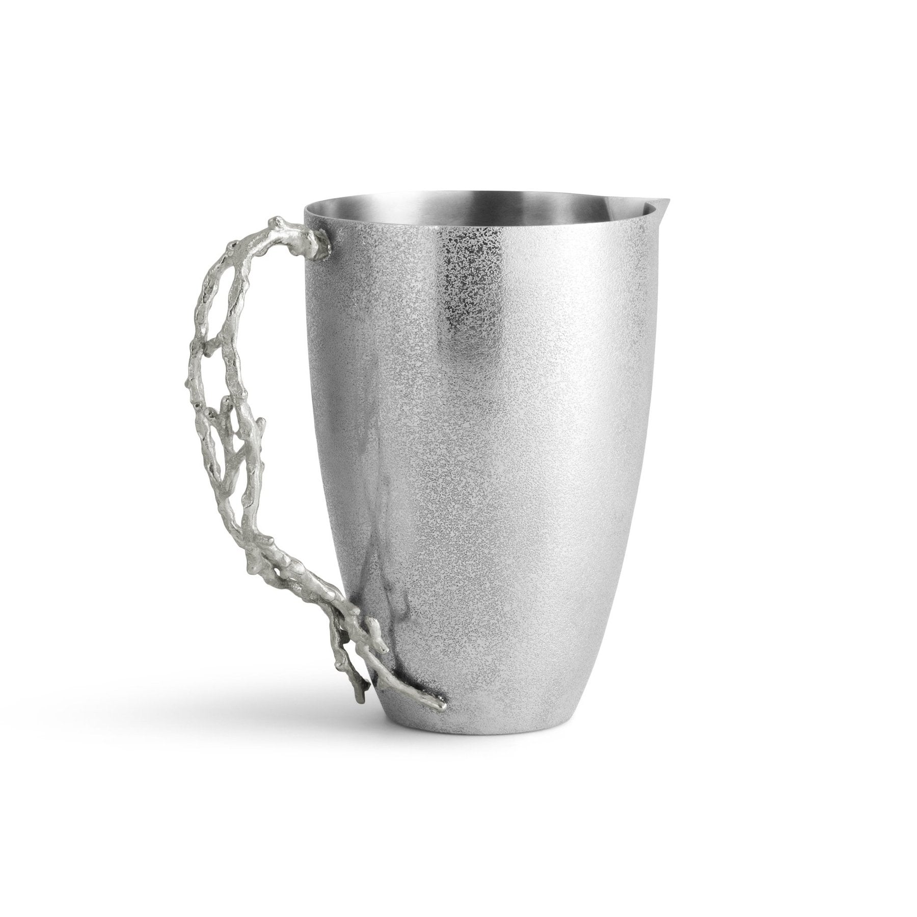 The Ocean Reef Pitcher by Michael Aram features a smooth matte finish and a sculptural, branch-like handle. Crafted from hand-textured stainless steel, it is photographed against a plain white background.