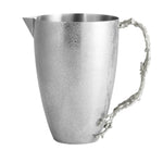 The Michael Aram Ocean Reef Pitcher features a matte, hand-textured stainless steel finish and a handle inspired by coral reef branches.